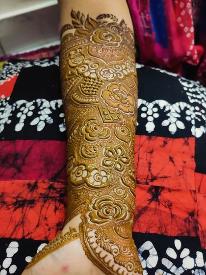 A full arm design showcasing a variety of techniques, including shaded roses, fine lines, and bold patterns.