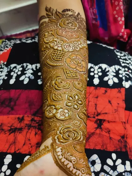 A full arm design showcasing a variety of techniques, including shaded roses, fine lines, and bold patterns.