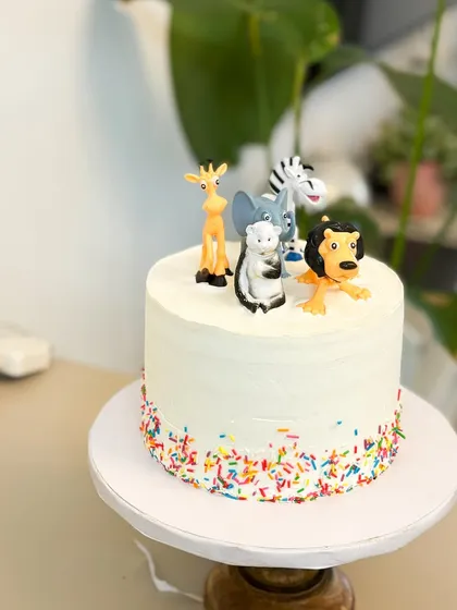 Let's get wild. This simple and sweet animal-themed cake is perfect for a young child's birthday, topped with their favorite animal figures and colorful sprinkles.