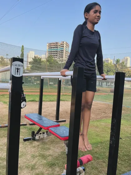 Working on dip-holds at our Kanjurmarg park. The city skyline provides an inspiring backdrop for our workouts.