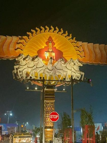 The Surya Stambh, a grand pillar depicting the Sun God's chariot, illuminated at night in Ayodhya. It stood as a magnificent beacon in the city.