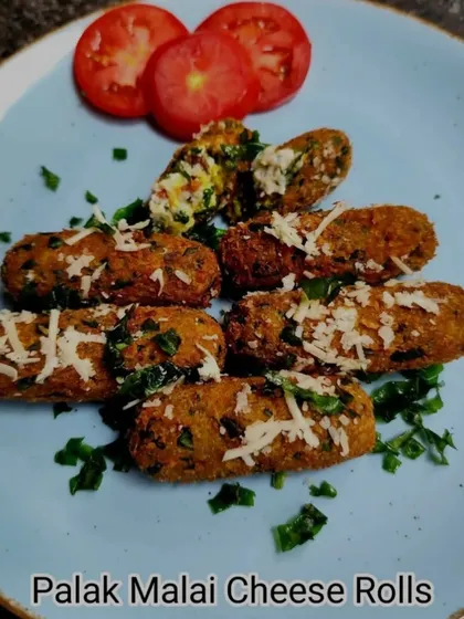 A perfect snack for a rainy day, our Palak Malai Cheese Rolls are crispy on the outside with a creamy spinach and cheese filling. A true comfort food starter.