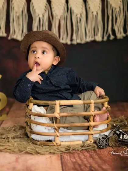 A thoughtful moment from a six-month session. This little boy looks so charming and contemplative in his little hat.