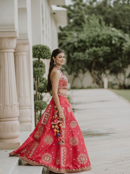 Another angle of our stunning pink Mehendi lehenga, showing how the skirt flows beautifully. The colorful tassels on the side add a playful touch.