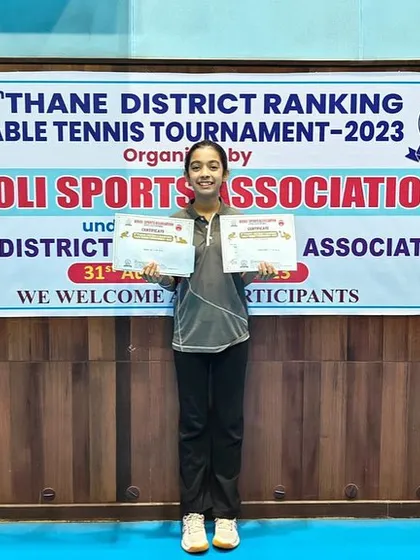 Hrithika Madhur holds her certificates after strong performances in the U-19 and U-17 categories at the 5th Thane District Ranking Tournament.