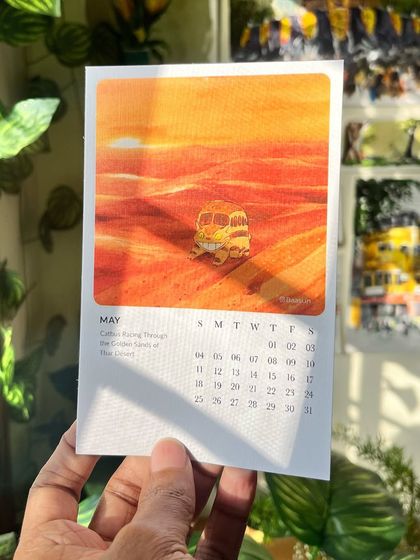 A close-up of the May page from my Ghibli calendar, featuring the Catbus in the Thar Desert. The textured paper really brings out the warmth of the illustration.