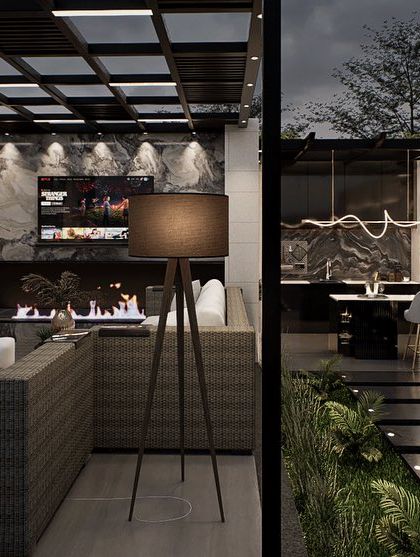 This view shows the lounge area of the luxury terrace, complete with a fireplace and outdoor television. The design uses a moody, sophisticated palette and high-end finishes to create an opulent space for relaxation and entertainment.