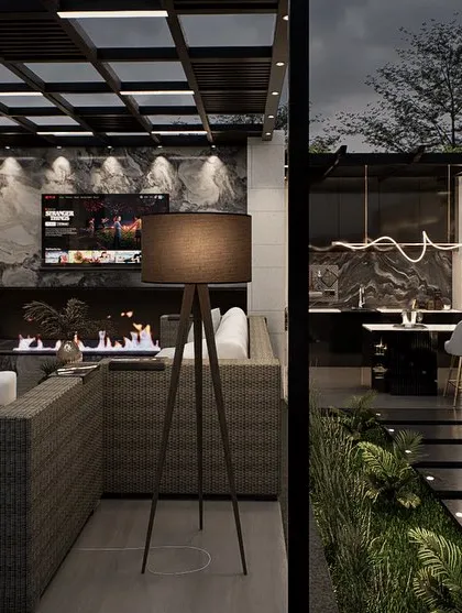 This view shows the lounge area of the luxury terrace, complete with a fireplace and outdoor television. The design uses a moody, sophisticated palette and high-end finishes to create an opulent space for relaxation and entertainment.