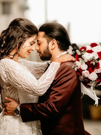 A 'first look' portrait filled with emotion. The soft light and their close embrace capture the intimacy and anticipation of seeing each other for the first time on their wedding day.