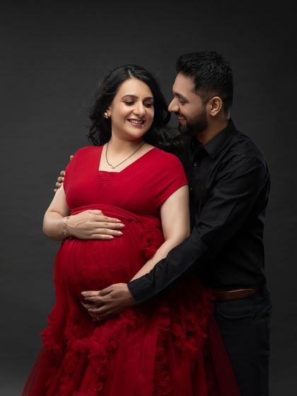 A classic couple's portrait with the elegant red ruffled gown. Their loving gaze towards each other tells a beautiful story.