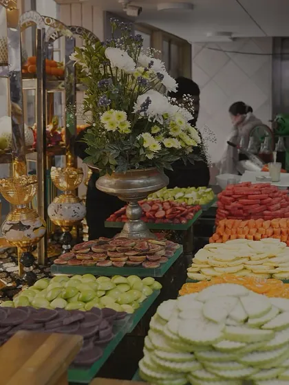 A vibrant fruit station, showcasing an abundant and colorful display of freshly sliced fruits, presented with the same level of care as our main courses.