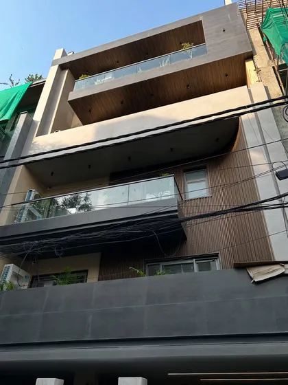 A completed residential project in CR Park, showing the final facade with wood-look HPL panels, glass railings, and textured paint. This is the result of our full design-to-execution process.