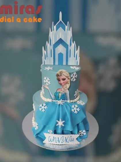 I bring fairy tales to life with creations like this stunning two-tier Frozen cake. It features an edible image of Queen Elsa, a beautifully crafted ice castle topper, and intricate snowflake details, making it a magical centerpiece for any princess party.