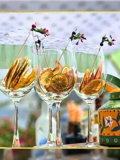 A trio of our elegant wine glasses, filled with dried citrus slices and adorned with artistic floral stirrers. Even an empty glass can be a work of art.