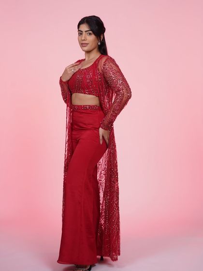 A full-length view of the red three-piece Indo-Western set. This outfit is all about making a bold and confident statement.