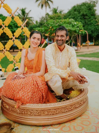 A full view of Eli and Suman's Haldi ceremony setup. The bright yellow and orange colors create a festive and joyful atmosphere.