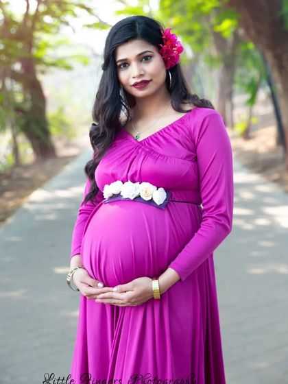A striking portrait in a magenta gown with a floral belt. The pop of color and the confident pose make this a powerful and beautiful maternity photo.