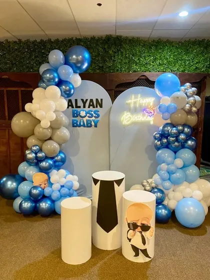 The Boss Baby theme is a favorite, and I love creating these fun setups. This one includes two custom backdrops, balloon arches in a blue, white, and grey theme, and character-themed cylindrical tables for the cake cutting ceremony.