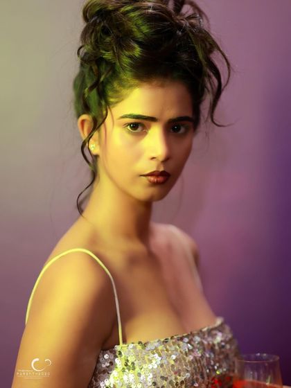 A powerful and direct black and white close-up. The lighting is dramatic, and her gaze is intense and captivating.