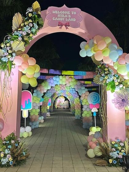 A night view of the 'Candy Land' entrance, where the lighting brings the entire magical setup to life.