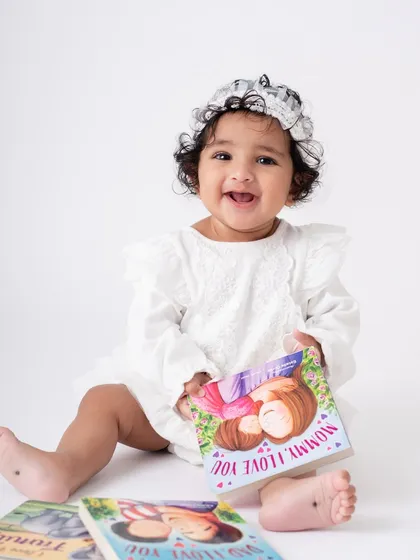 We can incorporate your baby's favorite books and toys into the session. It makes them feel comfortable and helps capture their personality. This little bookworm is ready for story time.