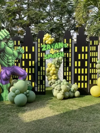 Time for a Hulk Smash. This superhero-themed party features a giant Hulk cutout against a city skyline backdrop, perfect for a powerful 4th birthday celebration.
