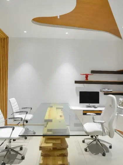 The MD's cabin at the AMG office features meticulously designed cabinets and floating shelves. The entire space exudes a sense of completeness, reflecting the strength of a well-balanced contemporary design.