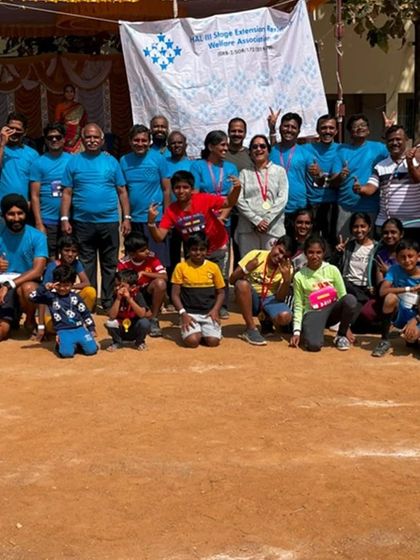 A large group photo from a community event. We are proud to be a diverse group, with members of all ages and backgrounds coming together.