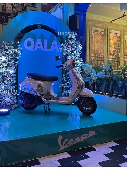 Here is another view of the main stage for the custom painted Vespa. The elevated platform, branded base, and professional lighting ensure the product is visible and looks spectacular from every angle.