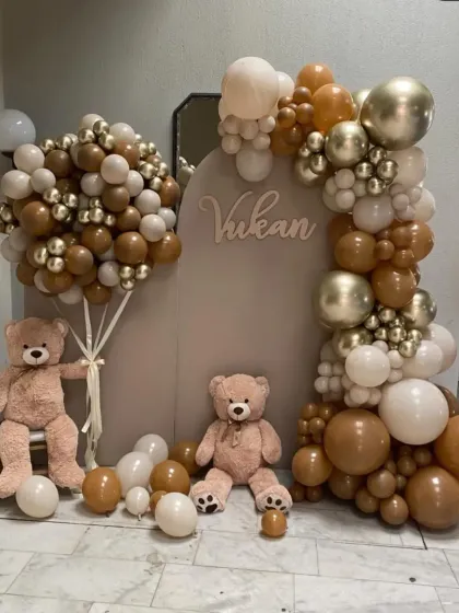 A sophisticated and modern teddy bear theme for a baby celebration. This setup uses a neutral color palette of brown, beige, and gold balloons, paired with a custom backdrop and adorable teddy bears for a chic and heartwarming look.