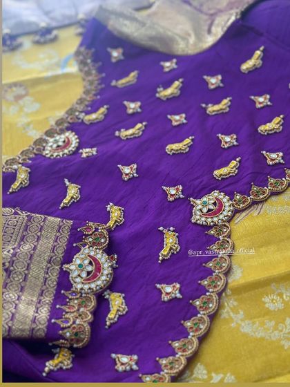 A rich purple blouse adorned with mango and crescent-shaped motifs, inspired by traditional South Indian jewellery. The detailing is done with kemp stones and zardosi for a classic bridal look.