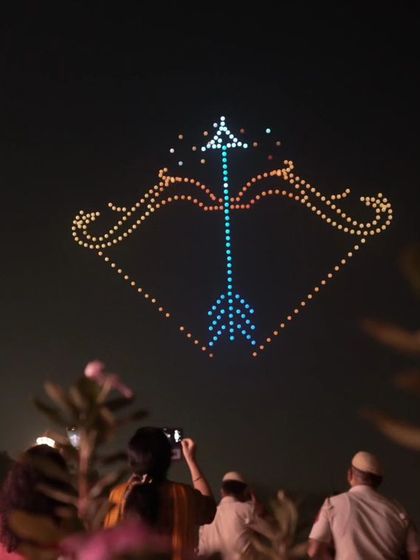 A bow and arrow formation from our Dilli Deepotsav show, symbolizing the victory of Lord Ram. The crowd watches, capturing the moment where mythology and technology meet.