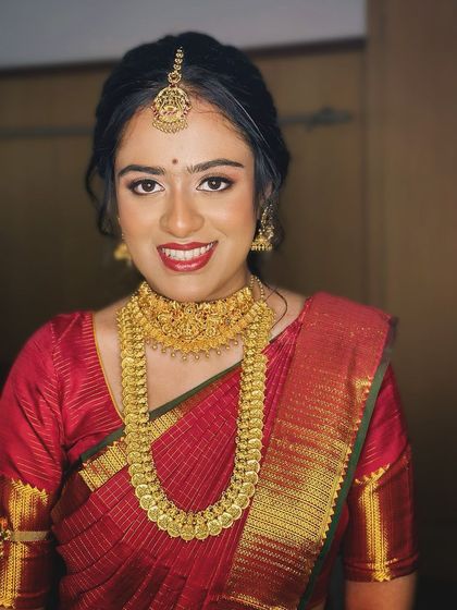 A happy, smiling portrait of the bride, her classic makeup look enhancing her joy.