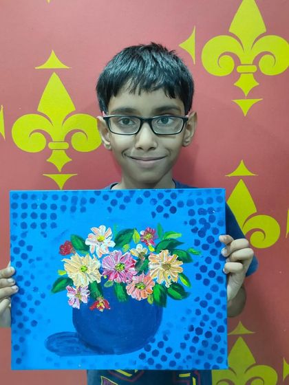 The final result of our kids' floral canvas painting course. This young artist did a fantastic job creating a vibrant bouquet with a fun, patterned background.