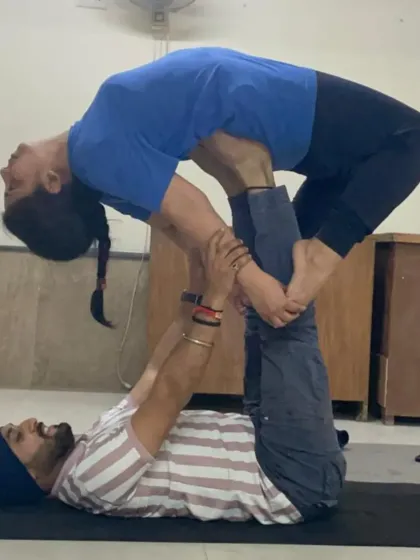 A compact and stable Acro Yoga pose that requires open hips and trust. It's a great example of the connection we build in partner practice.