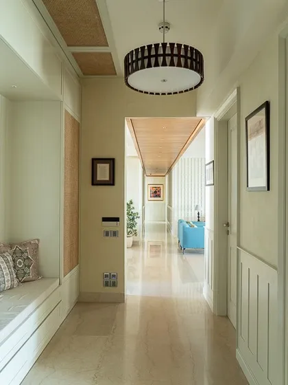 This light-filled entryway is a perfect example of turning a client's dream into reality. I designed a multifunctional unit with a comfortable seating area, all wrapped in crisp white tones and accented with beautiful rattan inlays for texture.