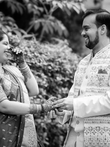 A timeless black and white photograph capturing a moment of pure, uninhibited laughter. This artistic choice focuses entirely on the emotion and connection between the couple.