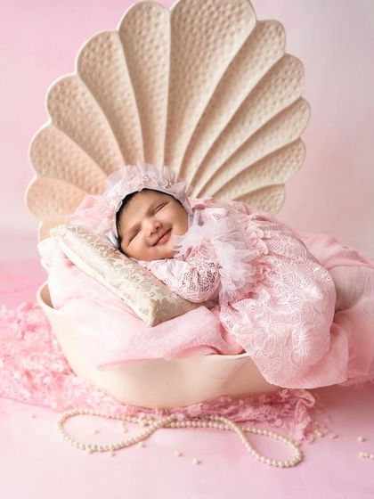 Your baby is a precious pearl, and this setup brings that idea to life. Nestled in a beautiful seashell prop, this little one is the definition of a hidden treasure.