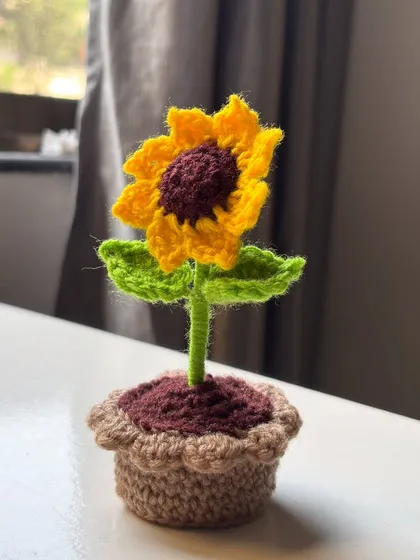 Here's a plant you can't kill. This cute, zero-maintenance potted crochet sunflower is perfect for brightening up your desk or any small space without the need for a green thumb.