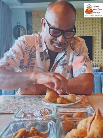 Our official taste tester, Dadisaa's husband, enjoying the first bite of a fresh batch. Every new snack is tasted and approved at home before it reaches you.