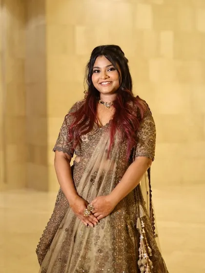 A full portrait of the bride's sister. She looks confident and beautiful, ready to celebrate the big day.