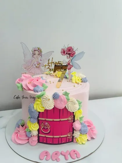 A fairy door cake for Arya's 7th birthday. The colorful buttercream flowers and whimsical fairies make it an enchanting choice.
