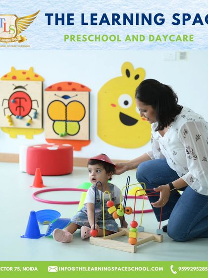 A teacher guides a toddler with a bead maze in our innovation lab. These activities are designed to build fine motor skills and problem-solving abilities from the very beginning.