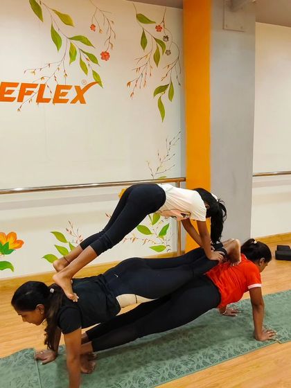 Building a bridge of strength, three people at a time. This partner pose is a creative and challenging way to work on core and leg strength as a team.