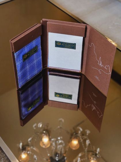 This is a Loro Piana fabric swatch book, showing samples of fine wools. Gifting a length of such a prestigious fabric is a statement of pure class.