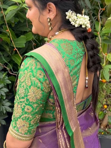 A back view of the green embroidered blouse, featuring a simple tie-up detail.