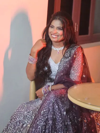 Another shot of the bride in her sparkling reception lehenga. The makeup is glamorous, with a focus on her smiling eyes.