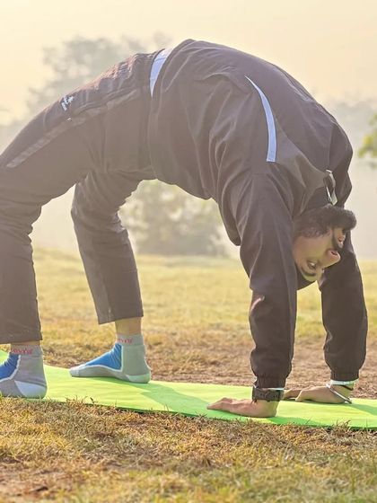 A student holds a deep Chakrasana (Wheel Pose) in our outdoor class. This pose is a powerful heart opener and strengthens the entire back of the body.