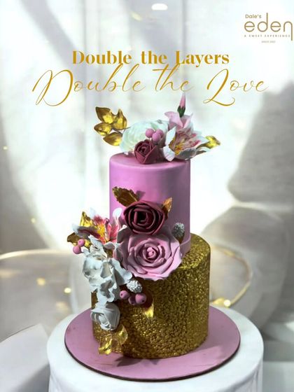 Double the layers, double the love. This two-tier cake combines a glittering gold bottom tier with a chic pink top tier, adorned with handcrafted sugar flowers for a glamorous celebration.