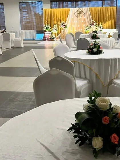 We ensure the entire venue is decorated to match the theme, including simple and elegant floral centerpieces for the guest tables.